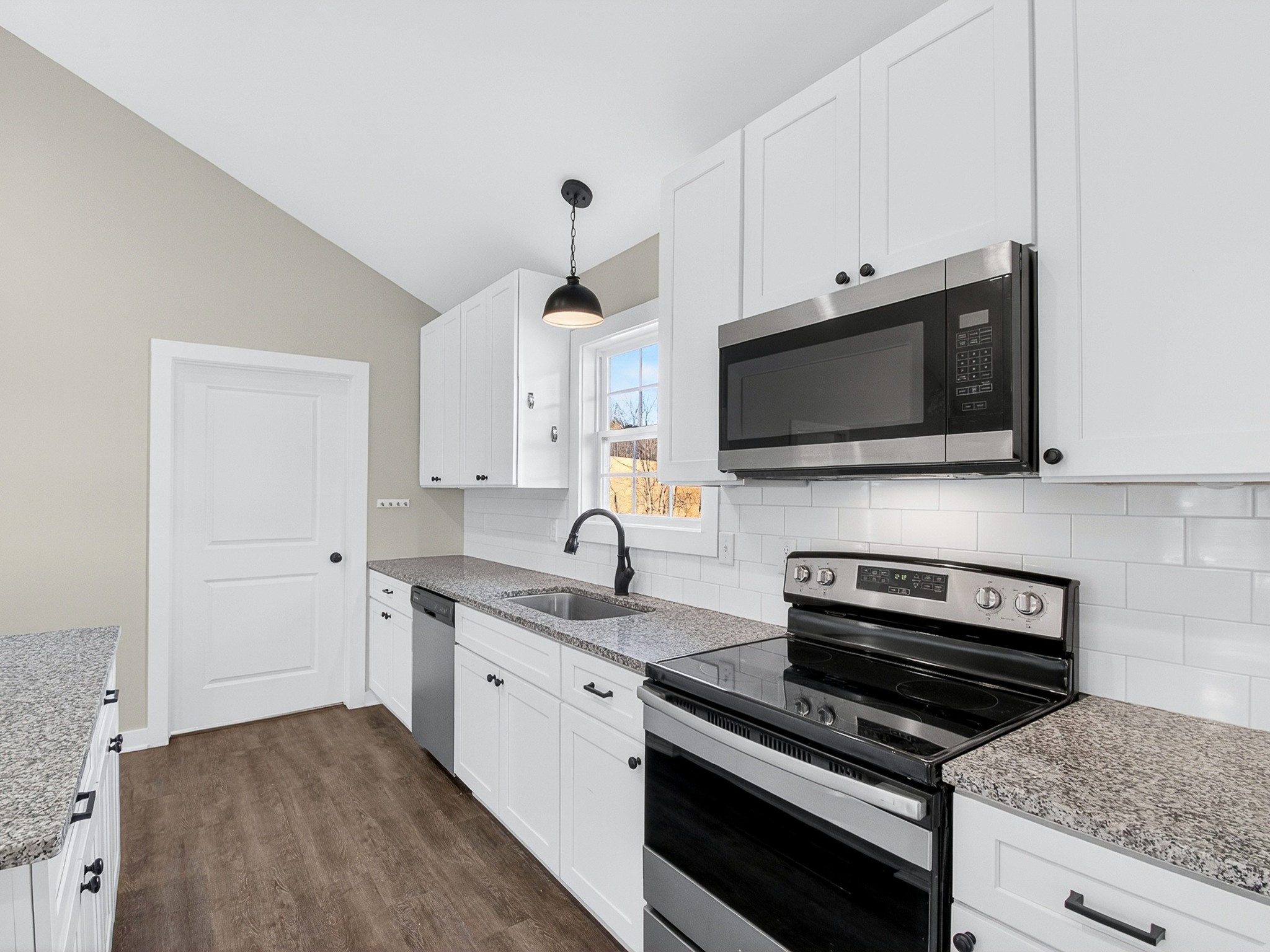 621 Womack Road Bethpage, TN 37022 - Photo 18 of 50 a kitchen with stainless steel appliances a stove a sink and a microwave