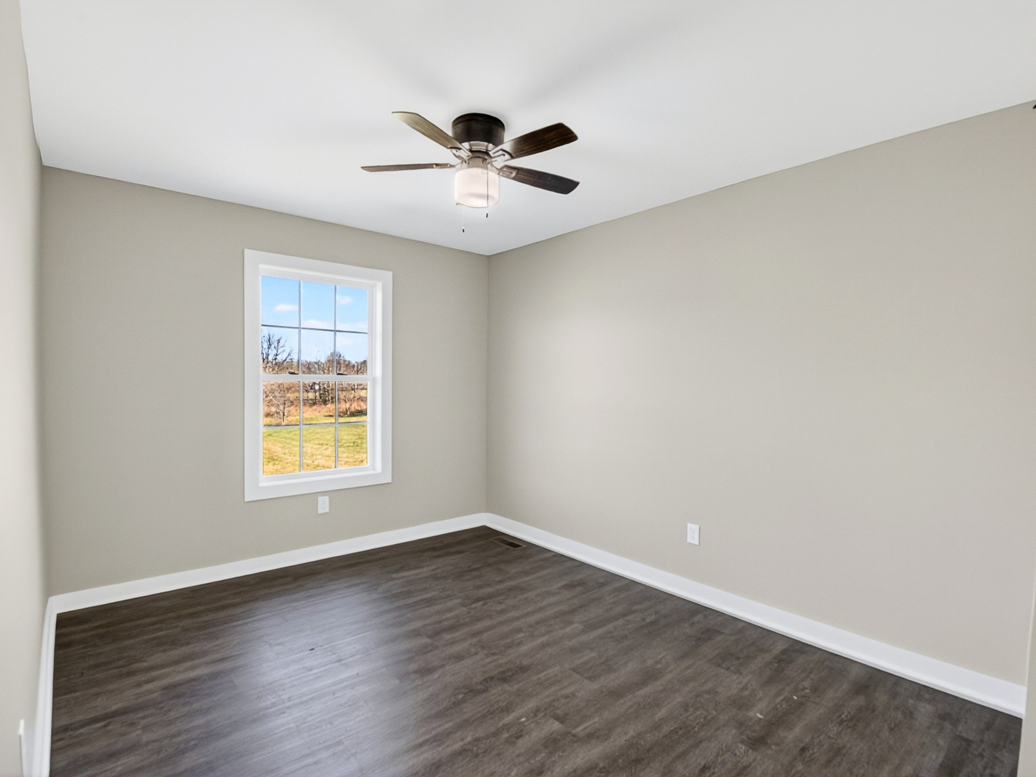 621 Womack Road Bethpage, TN 37022 - Photo 29 of 50 an empty room with wooden floor fan and windows