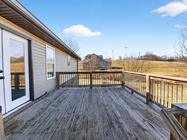 a view of a house with wooden deck