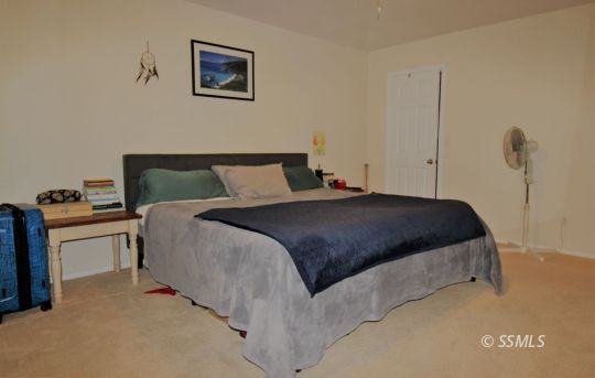 1100 West Iowa Avenue Ridgecrest, CA 93555 - Photo 15 of 19 a bedroom with a bed and a desk