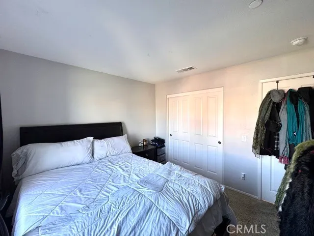 a bedroom with a bed and a walk in closet