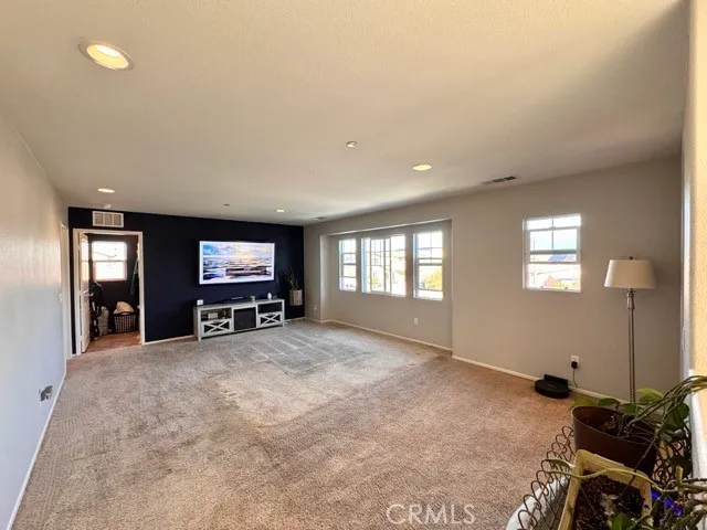 a view of a livingroom with furniture and a flat screen tv