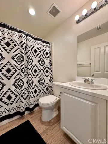 a bathroom with a sink toilet and a mirror