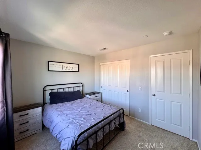 a bedroom with a bed and a closet