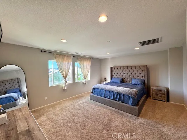 a bedroom with a large bed and a window