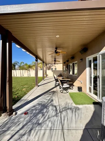 a roof deck with table and chairs and wooden floor