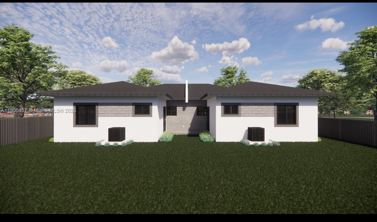 1440-1444 Northeast 147th Street Miami, FL 33161 - Photo 2 of 3 a view of a white house with a big yard and potted plants