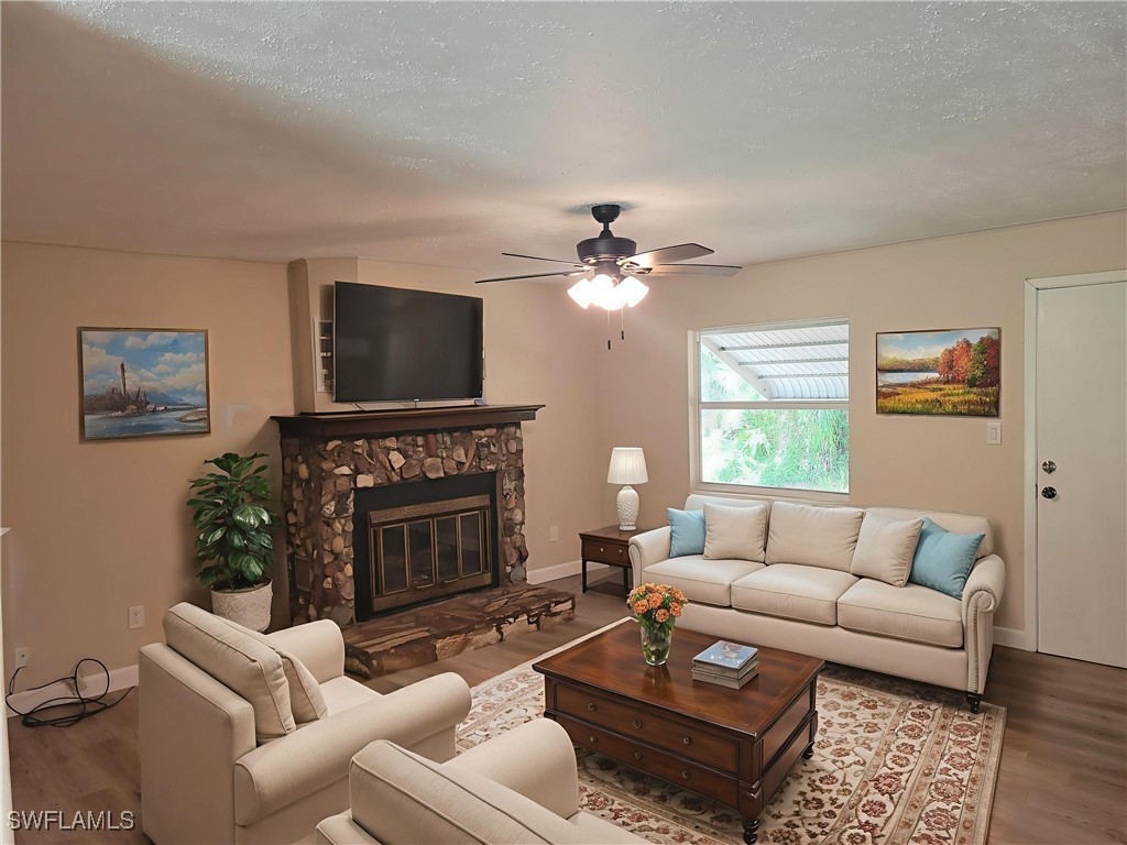 2371 County Road 78 LaBelle, FL 33935 - Photo 3 of 17 a living room with furniture a fireplace and a flat screen tv