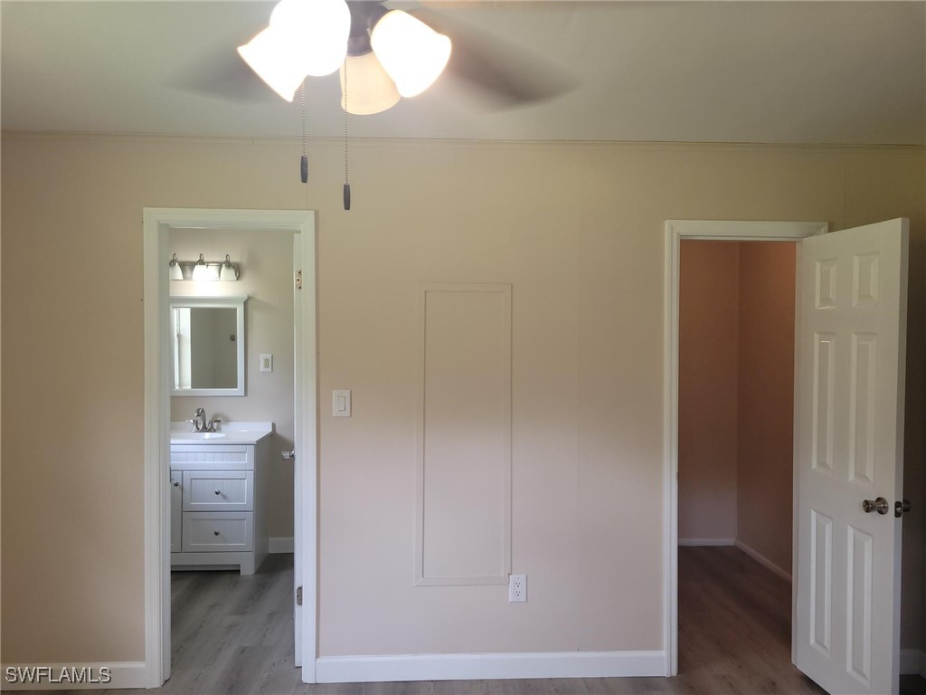 2371 County Road 78 LaBelle, FL 33935 - Photo 8 of 17 a bathroom with a light fixture a sink and a vanity