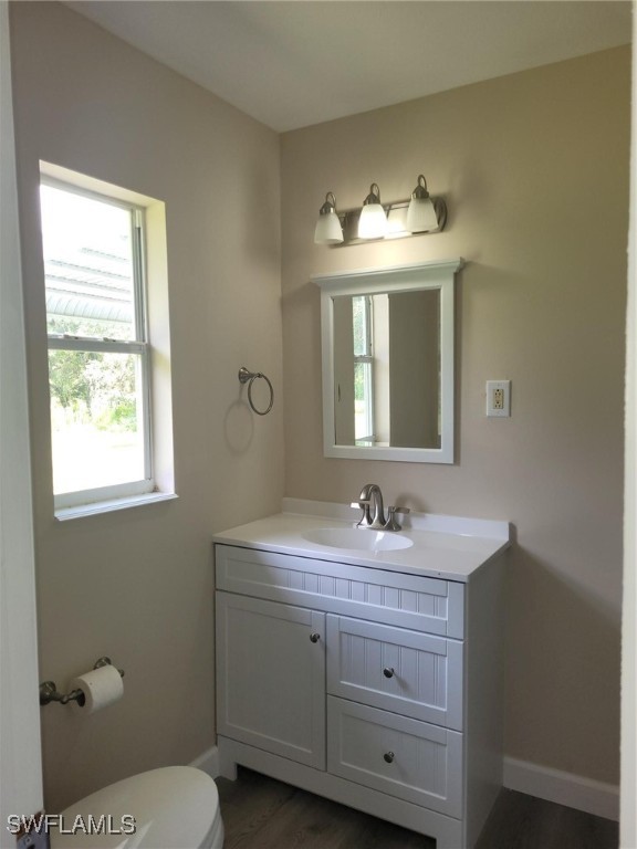 2371 County Road 78 LaBelle, FL 33935 - Photo 9 of 17 a bathroom with a toilet sink and mirror