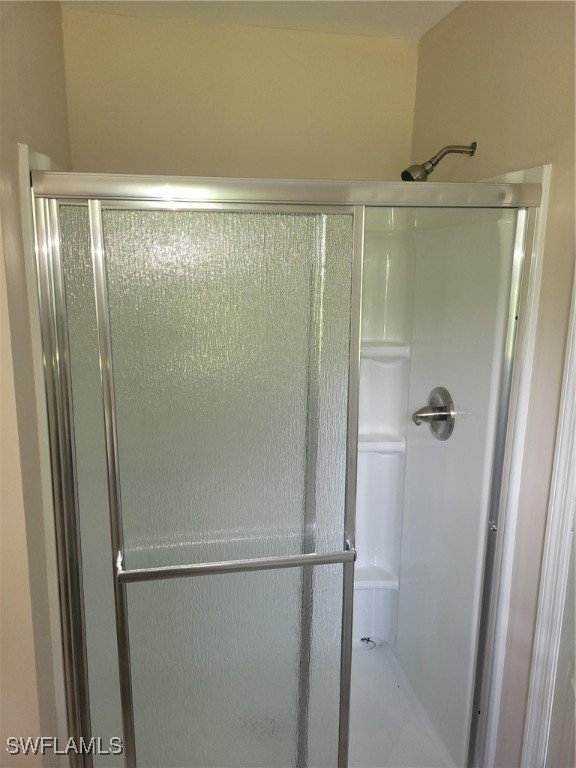 2371 County Road 78 LaBelle, FL 33935 - Photo 10 of 17 a bathroom with a glass shower door