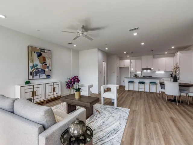 a living room with furniture and kitchen view