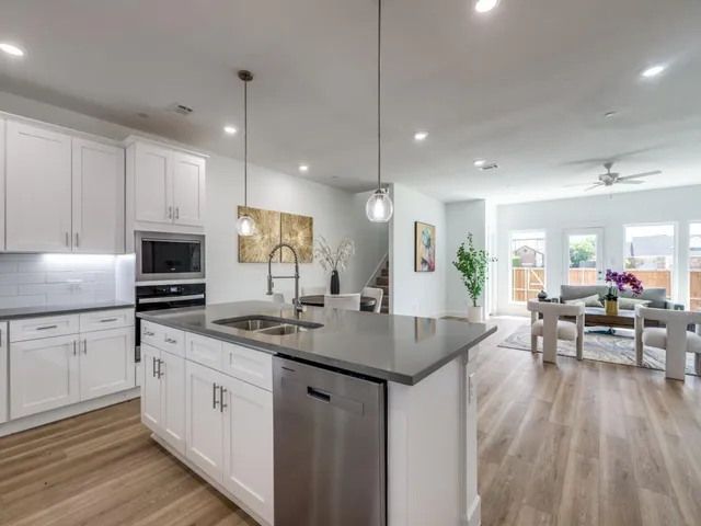a kitchen with counter space sink stove and cabinets