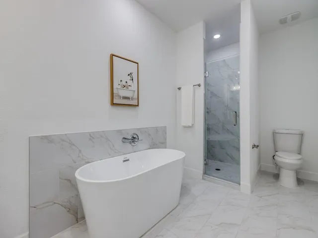 a bathroom with a bathtub and a toilet