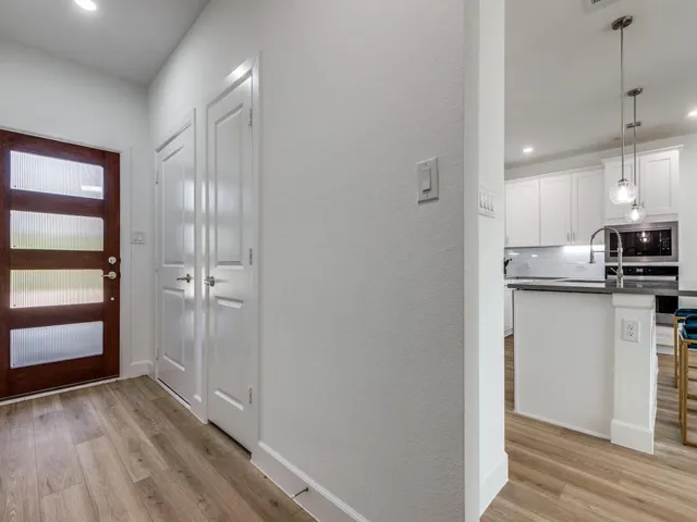 a view of kitchen with wooden floor electronic appliances and window