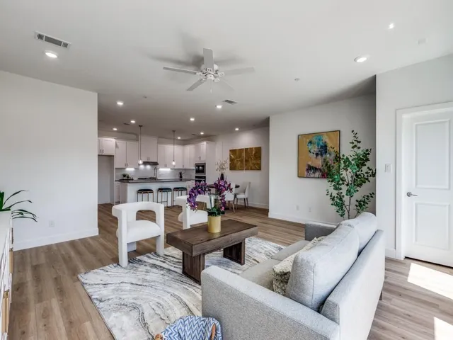 a living room with furniture and kitchen view