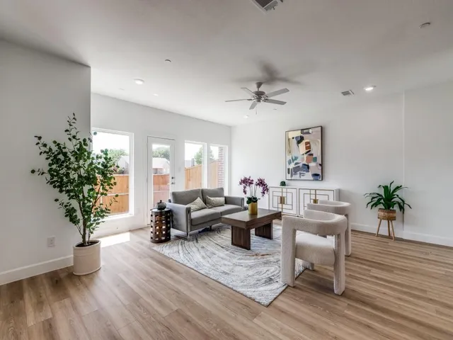 a living room with furniture and a potted plant