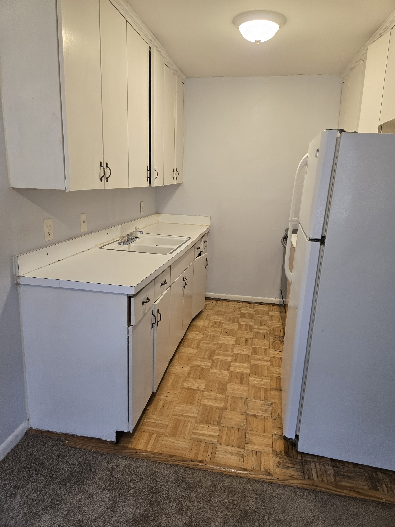 550 Harding Place, Unit E120 Nashville, TN 37211 - Photo 3 of 8 a room with a stove and a refrigerator