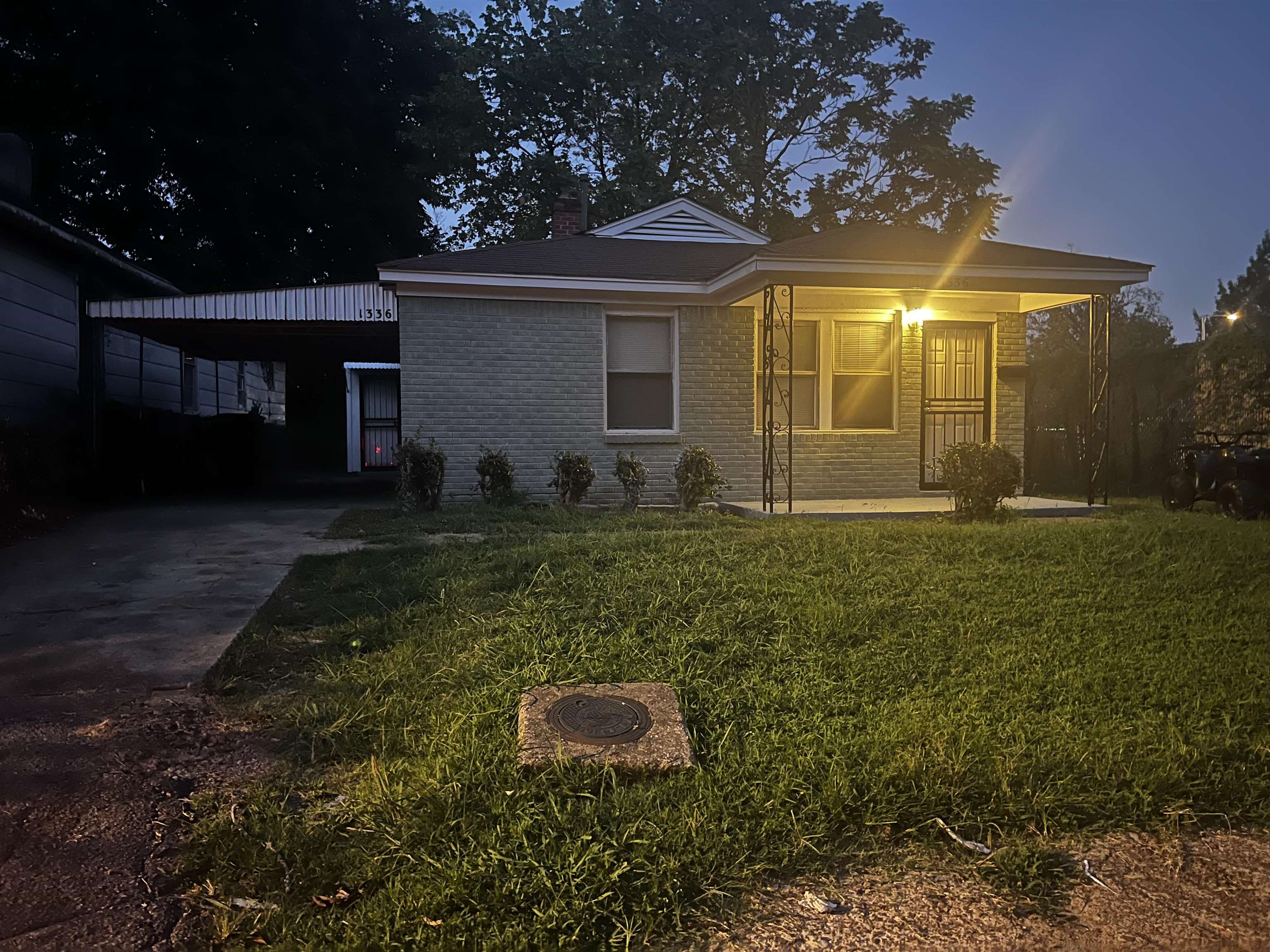 1336 James Street Memphis, TN 38106 - Photo 4 of 5 a backyard of a house with lots of green space and fountain