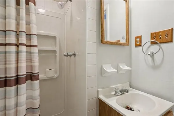 a bathroom with a toilet sink and shower