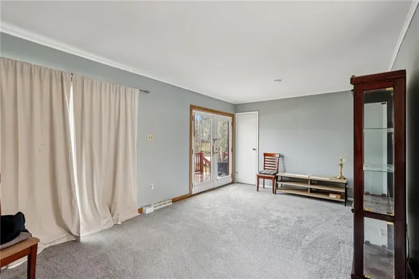 a view of a livingroom with furniture and staircase