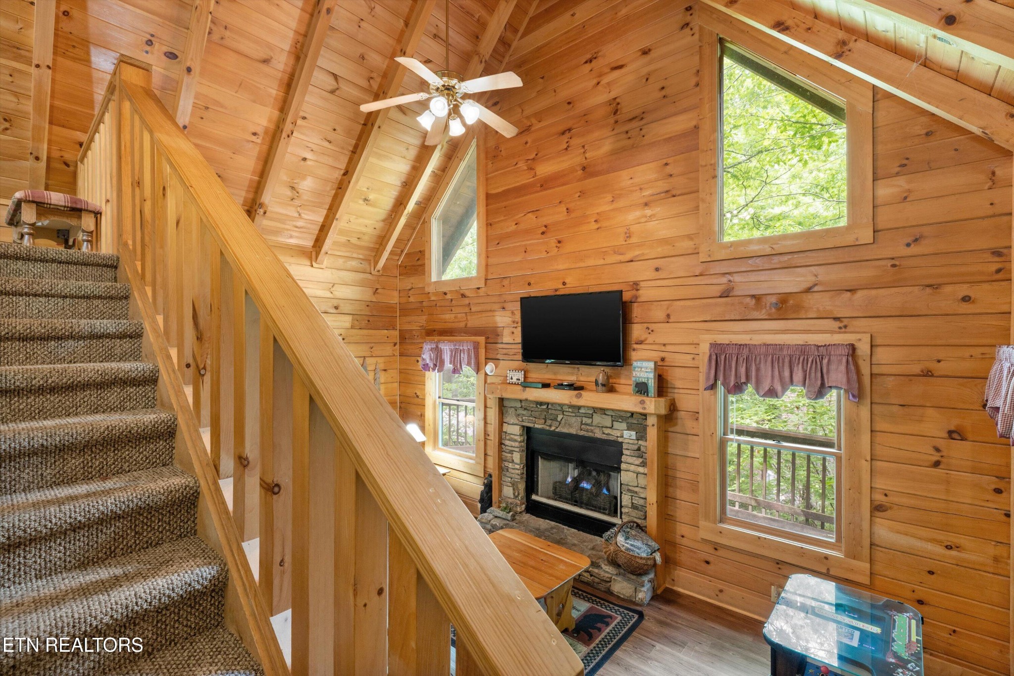 709 Grey Hawk Way Sevierville, TN 37863 - Photo 19 of 30 a living room with furniture a flat screen tv and a fireplace