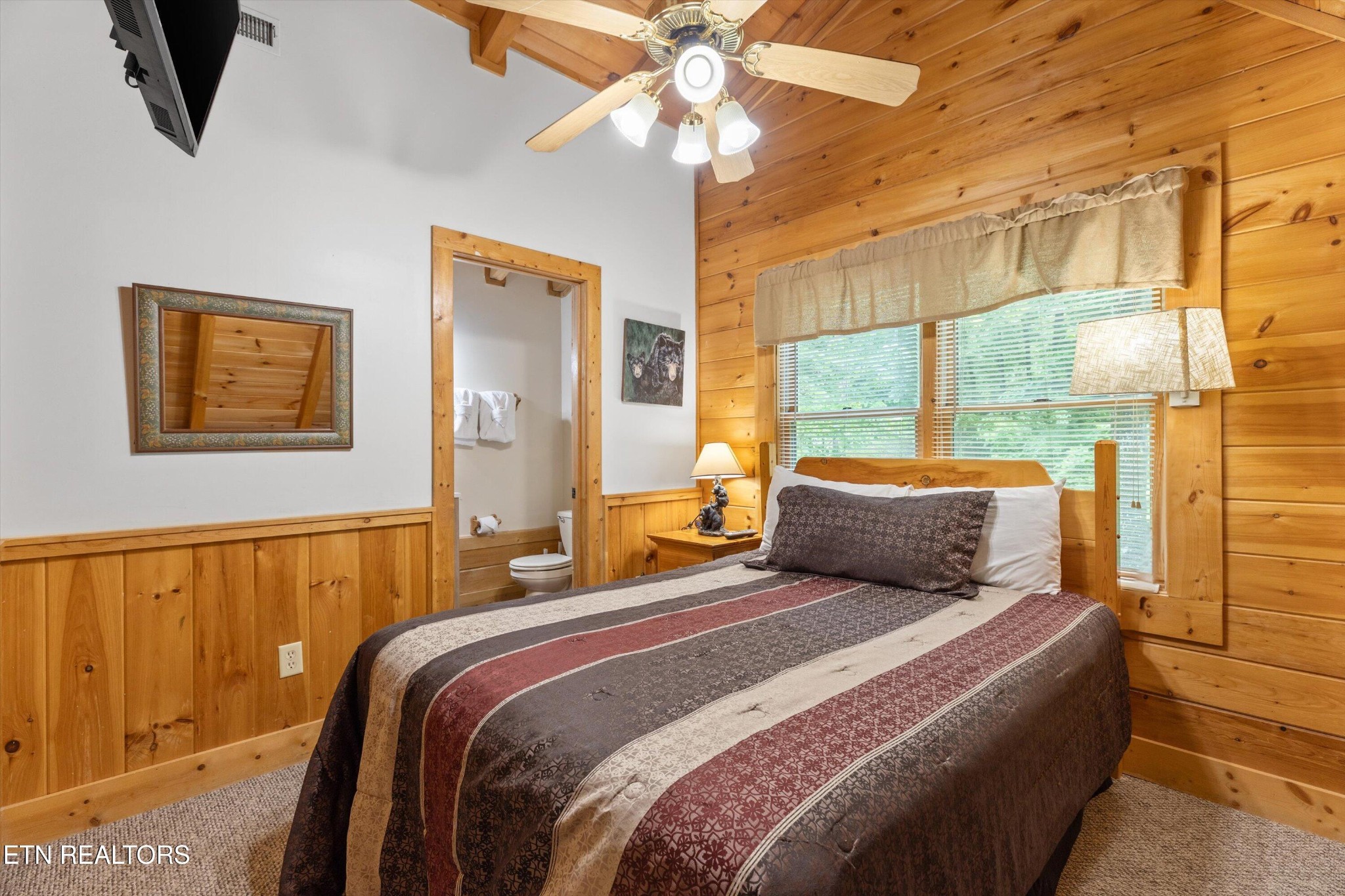 709 Grey Hawk Way Sevierville, TN 37863 - Photo 20 of 30 a bedroom with a large bed and a chandelier