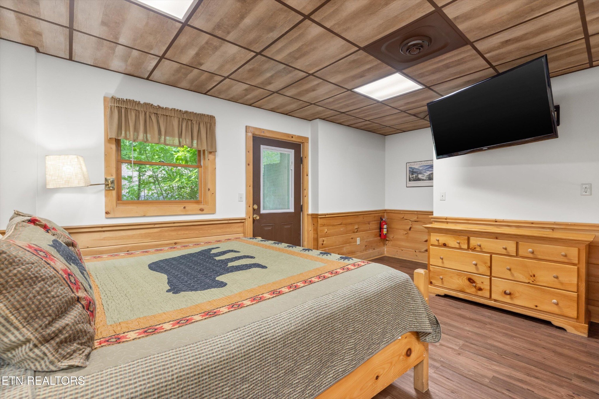 709 Grey Hawk Way Sevierville, TN 37863 - Photo 23 of 30 a bedroom with a bed and a flat tv screen on dresser
