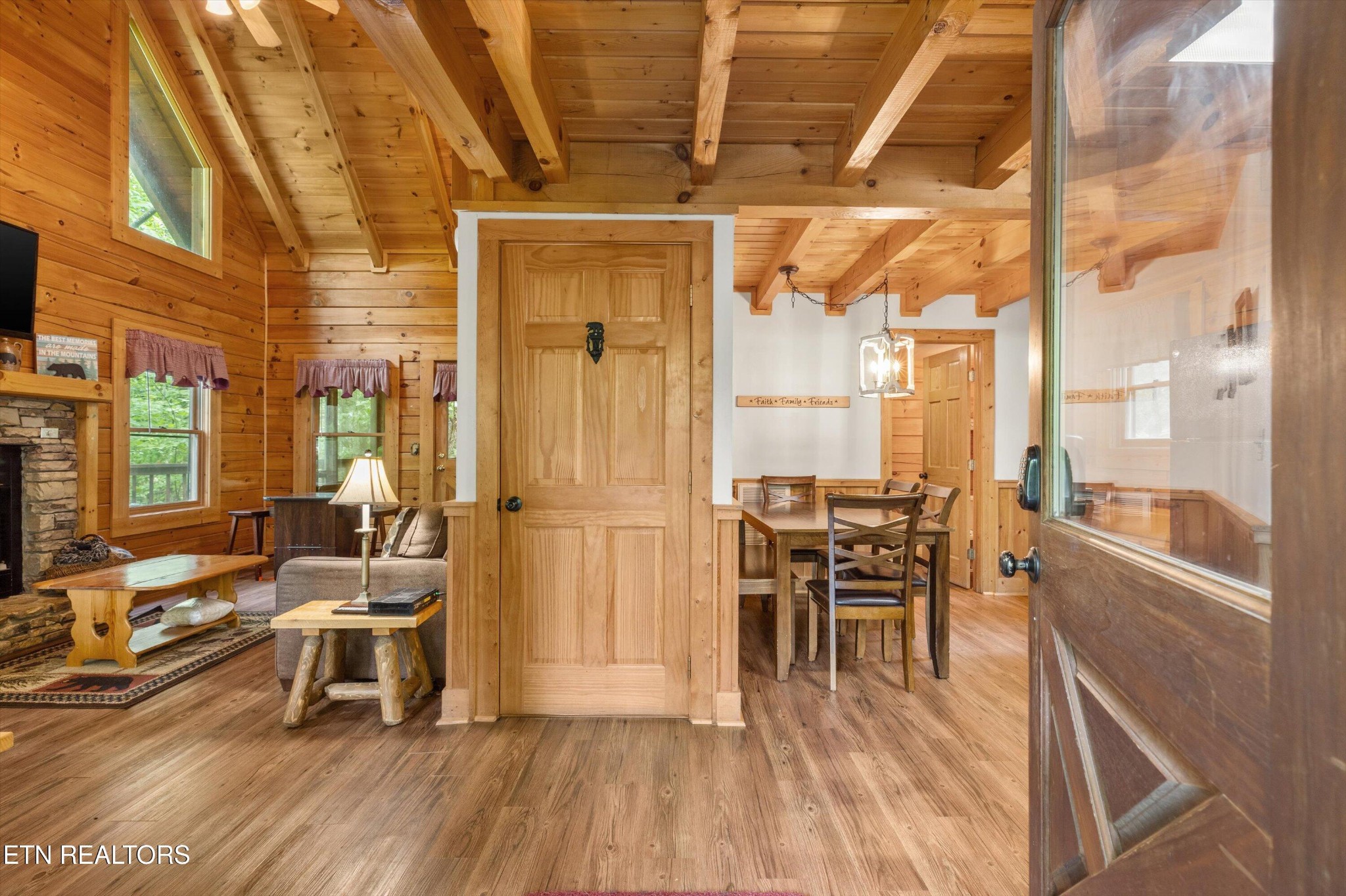 709 Grey Hawk Way Sevierville, TN 37863 - Photo 6 of 30 a dining room with wooden floor a chandelier a glass table and chairs