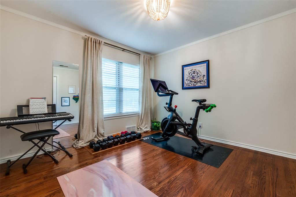 4159 Clover Lane Dallas, TX 75220 - Photo 12 of 25 Workout area featuring ornamental molding, baseboards, and wood finished floors