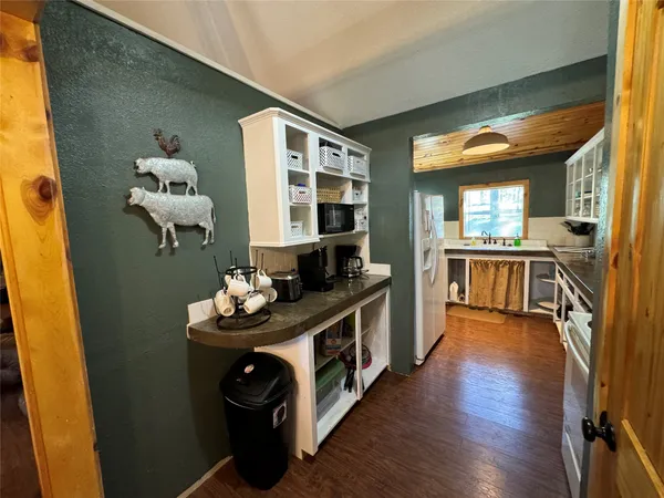 a kitchen with stainless steel appliances granite countertop a stove and a wooden floors