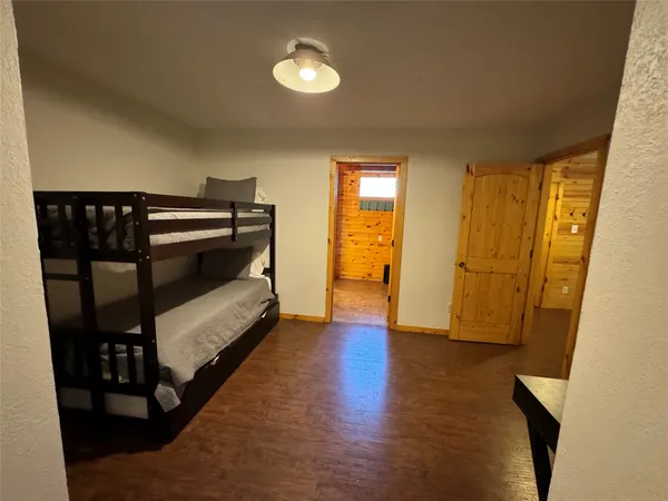 a view of a hallway with wooden floor and furniture
