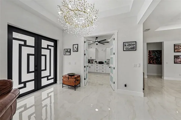 a living room with furniture and a chandelier