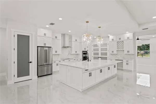 a kitchen with stainless steel appliances a refrigerator sink and cabinets
