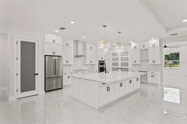 a kitchen with stainless steel appliances a refrigerator sink and cabinets