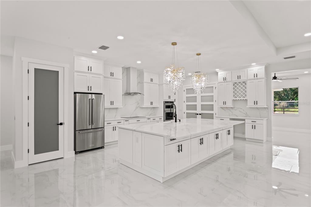 14060 Sydney Road Dover, FL 33527 - Photo 18 of 49 a kitchen with stainless steel appliances a refrigerator sink and cabinets