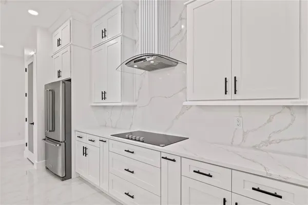 a kitchen with stainless steel appliances a refrigerator and cabinets