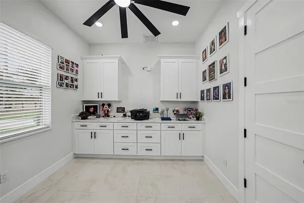 a kitchen with cabinets and window