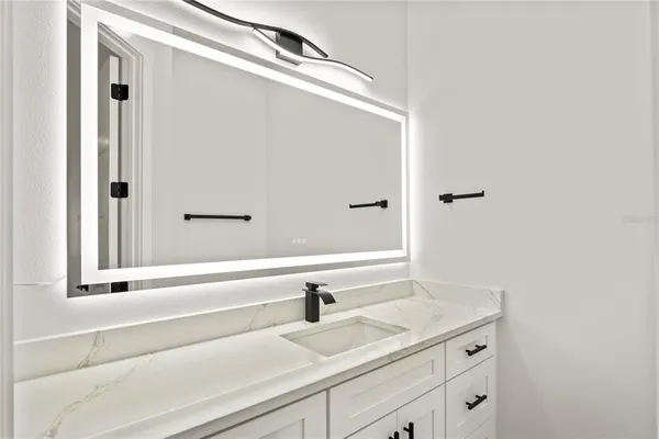 a bathroom with a sink and a mirror