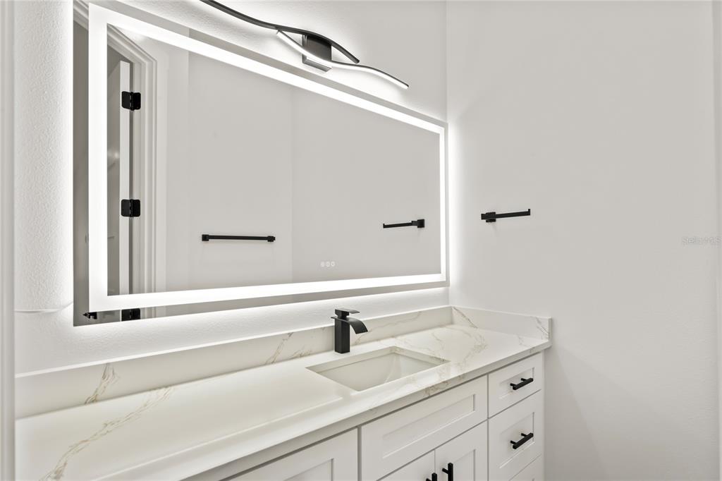 14060 Sydney Road Dover, FL 33527 - Photo 26 of 49 a bathroom with a sink and a mirror