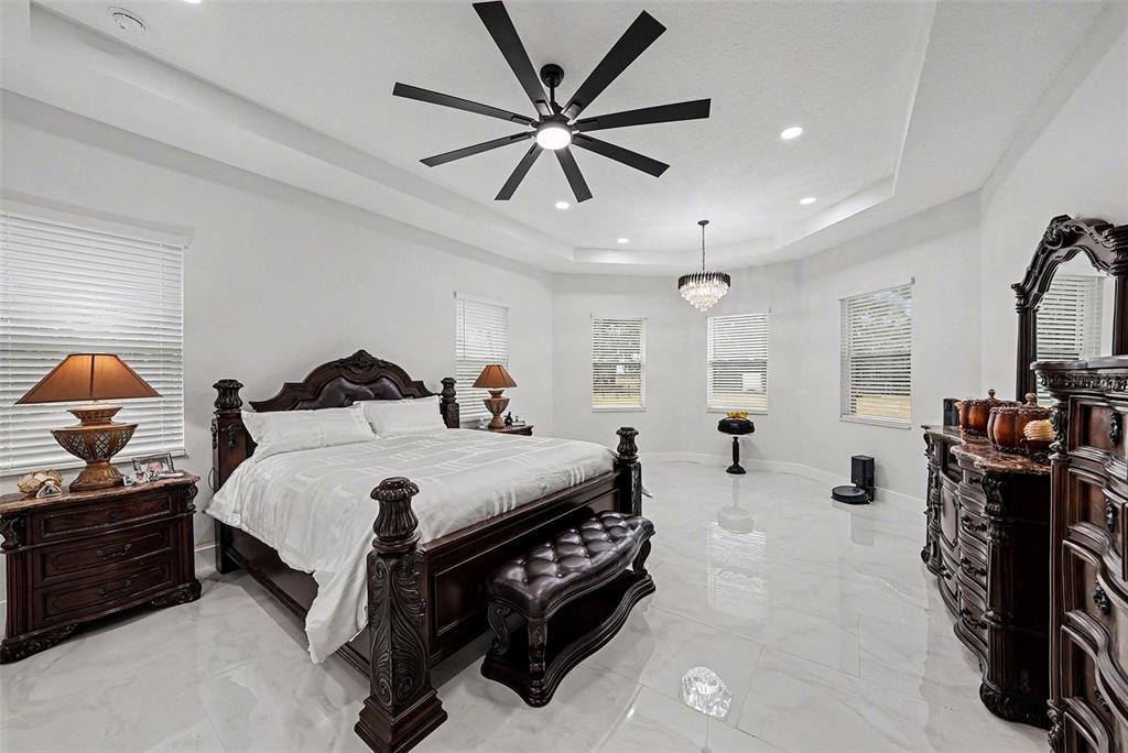 14060 Sydney Road Dover, FL 33527 - Photo 27 of 49 a spacious bedroom with a bed and a ceiling fan