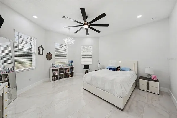 a bedroom with a bed and ceiling fan
