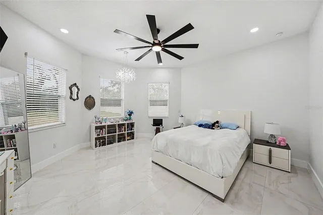 a bedroom with a bed and ceiling fan