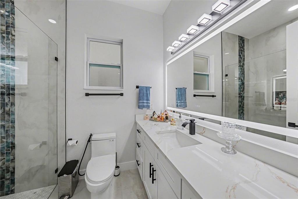 14060 Sydney Road Dover, FL 33527 - Photo 32 of 49 a bathroom with a sink vanity granite and toilet