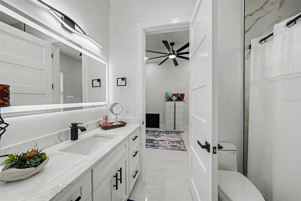 14060 Sydney Road Dover, FL 33527 - Photo 35 of 49 a bathroom with a sink a toilet and a mirror