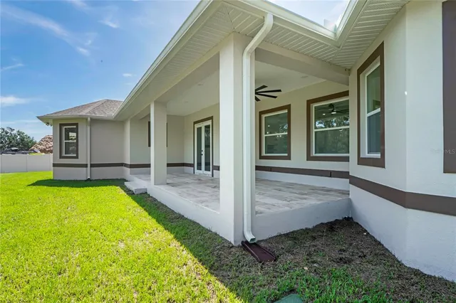 a view of house with backyard outdoor seating and hardwood