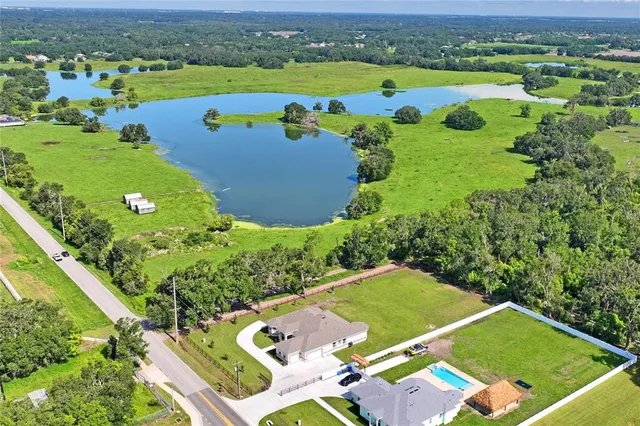 an aerial view of a pool yard and outdoor seating