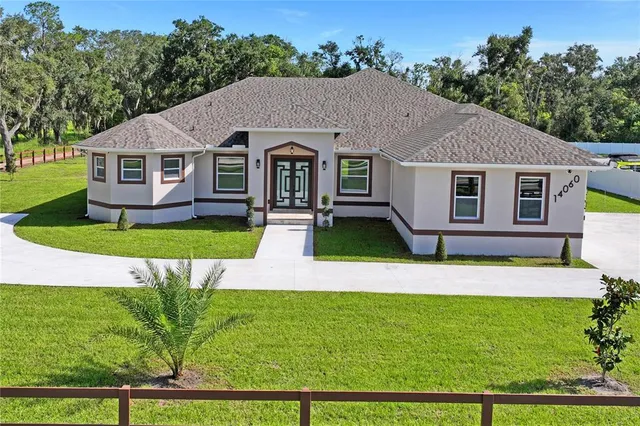 a aerial view of a house next to a big yard