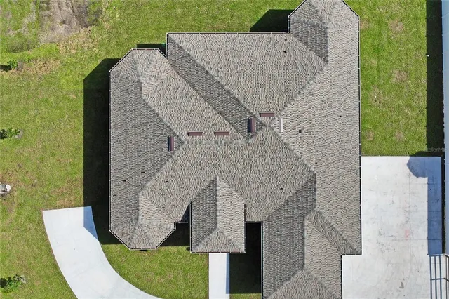 a aerial view of a house with a yard