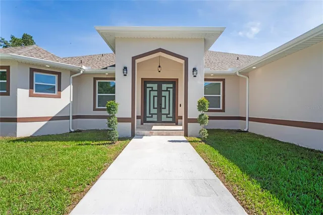 a view of a house with a garden and yard